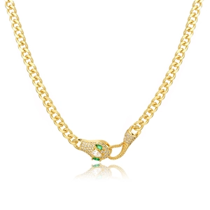 Detailed close-up of a gold Ouroboros pendant with green gems on a chunky Cuban chain