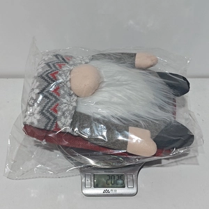 Detailed view of a Christmas gnome chair cover on a digital scale weighing 202.5 grams