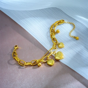 Layered gold-plated titanium steel bracelet with elegant heart charms and small gold beads