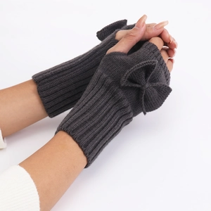 Detailed texture of dark grey knit fingerless gloves with bow accent on model hands