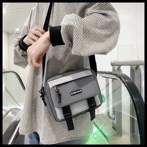 On-body view of grey cargo messenger bag with black buckles and PINBO BAG logo strap