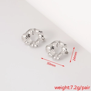 Detail view of silver textured flower earrings with size 30x24mm and 7.2g weight specs