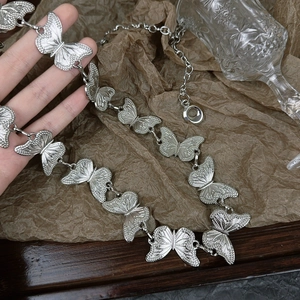 Silver butterfly link chain belt for women with elegant embossed metal texture detailing