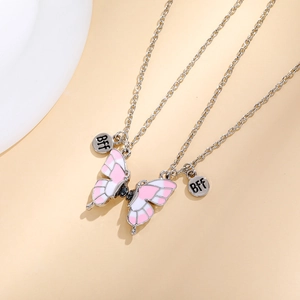 Close-up of silver chain with pink and white enamel butterfly pendant and BFF tag