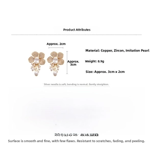 Detail view of flower earrings with zircon petals, large gemstone, and small pearls