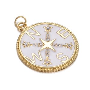 Detailed macro view of a gold-plated compass pendant with white enamel and zircons
