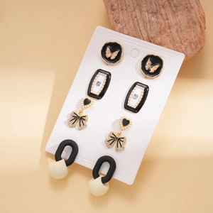 Detail view of vintage butterfly and pearl earrings set on display cards