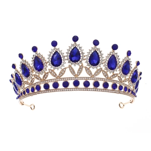 Macro detail of royal blue crystal gems and gold alloy frame on a vintage luxury crown