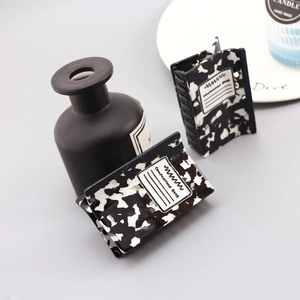 Detail of marble pattern hair claw clips with Composition Book design on grey background