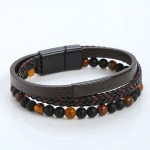 Detail of multi-layer braided leather bracelet with tiger eye beads and magnetic clasp