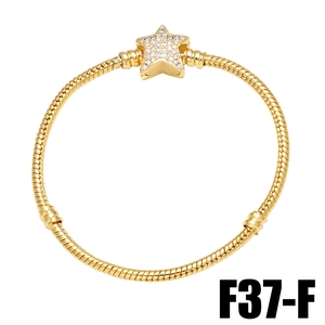 Detailed close-up of a gold snake chain bracelet featuring a micro-pave star charm