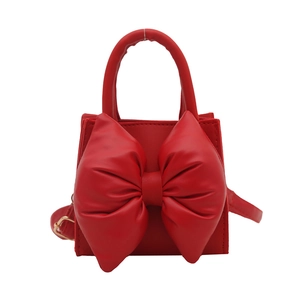 Fashionable red PU leather handbag for women featuring a large 3D bow and top handle