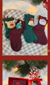 Detailed view of thick Christmas plush socks featuring cute 3D reindeer and Santa dolls