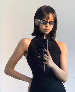 Close-up of black cat-eye cycling sunglasses featuring a distinct moon logo on the temple