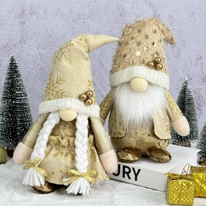 Golden and white Christmas gnomes with snowflake patterns and sequins decoration
