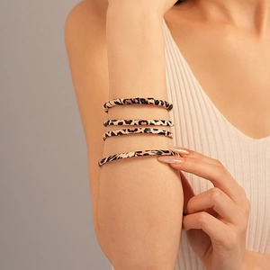 Set of four leopard print elastic bangles worn by model for a trendy aesthetic look