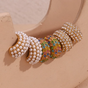 Detail of 18K gold-plated C-shaped earrings with colorful crystals and micro pearls