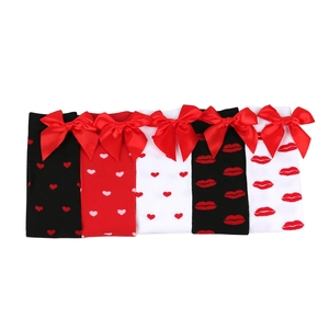 Detailed set of five knitted over-the-knee socks with heart patterns and red bows