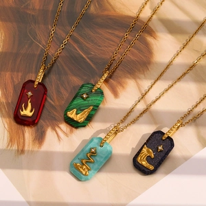 Detail of vintage square pendants in red, green, and blue on 18K gold plated chains