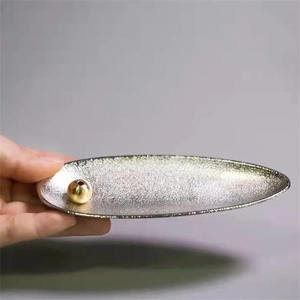 Japanese zen style metal incense holder with matte silver texture and gold bead detail