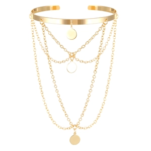 Detailed view of golden metal arm cuff with four-layer chain fringe and round pendants