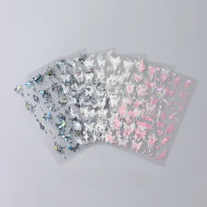 Macro shot of 3D laser silver butterfly nail art stickers with iridescent star and moon patterns