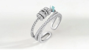 Detail of adjustable silver ring with rotating snowflake design and sparkling zircon stones