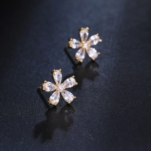 Elegant gold flower stud earrings with sparkling clear cubic zirconia crystals