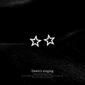 Macro shot of silver titanium steel pentagram star earrings on a dark textured surface