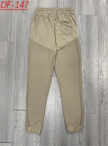 Detail view of khaki drawstring linen joggers with textured patchwork and back pocket detail