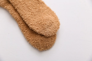 Detailed close-up showing the soft brown coral fleece texture of the thickened winter socks