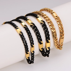 Detailed view of two-tone gold and black stainless steel Cuban link bracelets on a display
