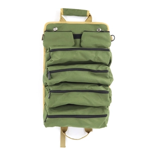 Detail view of military green roll-up tool bag with heavy-duty canvas and multiple zippers