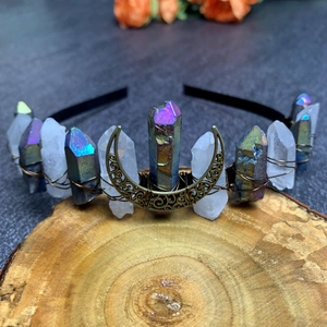Detail of colorful electroplated crystal crown with crescent moon on a black headband