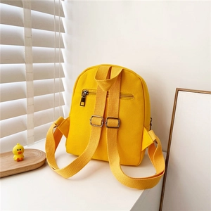 Bright yellow canvas toddler backpack with adjustable straps and rear zipper pocket