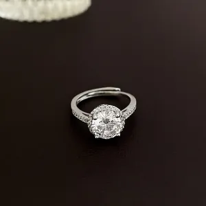 Silver bow heart open ring with a large round zircon stone in a six-prong setting