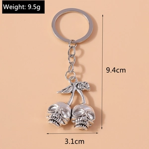 Detail view of gothic silver cherry skull keychain with size and weight measurements