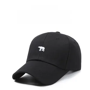Close-up of a black cotton baseball cap featuring detailed white polar bear embroidery