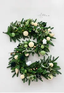 Detailed Christmas rattan with pine leaves, plaid ribbons, mini houses, and LED lights