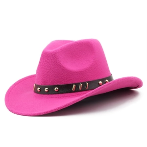 Detail of rose red felt cowboy hat featuring black leather band with golden metal studs