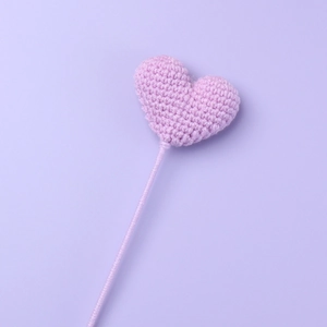 Handmade purple crochet heart flower on a thin stem for creative DIY gift bouquets