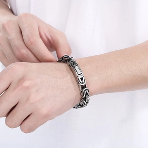 Close-up of men's silver Byzantine chain bracelet with a secure rectangle clasp on wrist