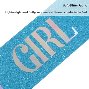 Detail of soft sky blue glitter fabric sash featuring iridescent Birthday Girl lettering
