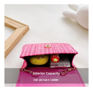 Detail view of pink tweed mini bag interior showing capacity for small accessories