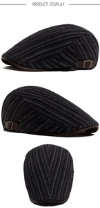 Detail view of newsboy cap with grey stripes and brown leather adjustable buckle