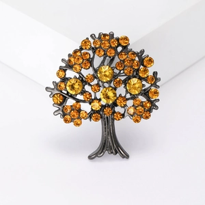Exquisite Tree of Life brooch with yellow crystals and dark alloy branches on white base