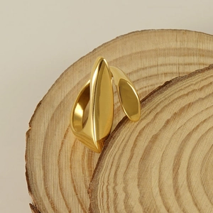 Polished 18k gold irregular geometric ring displayed on a natural wood piece