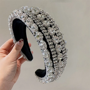 Detailed close-up of premium sparkling rhinestones on a wide sponge headband