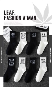 Detail of crew socks with monster patterns and ribbed cuffs in black and white colors