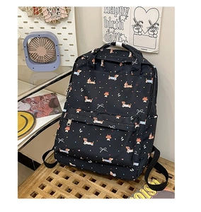 Detail of black backpack with cute dachshund and bow print on a wooden bench